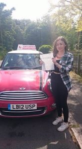 Molliie Maee with her driving test pass certificate